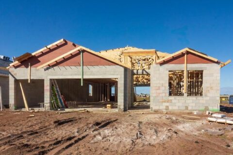 A house under construction with a blue sky