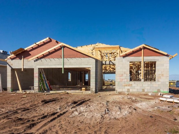 A house under construction with a blue sky