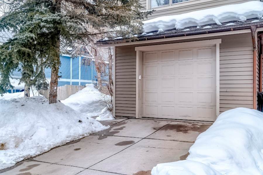 A garage in Chicago, IL, surrounded by a thick layer of snow on the driveway, highlighting the winter season