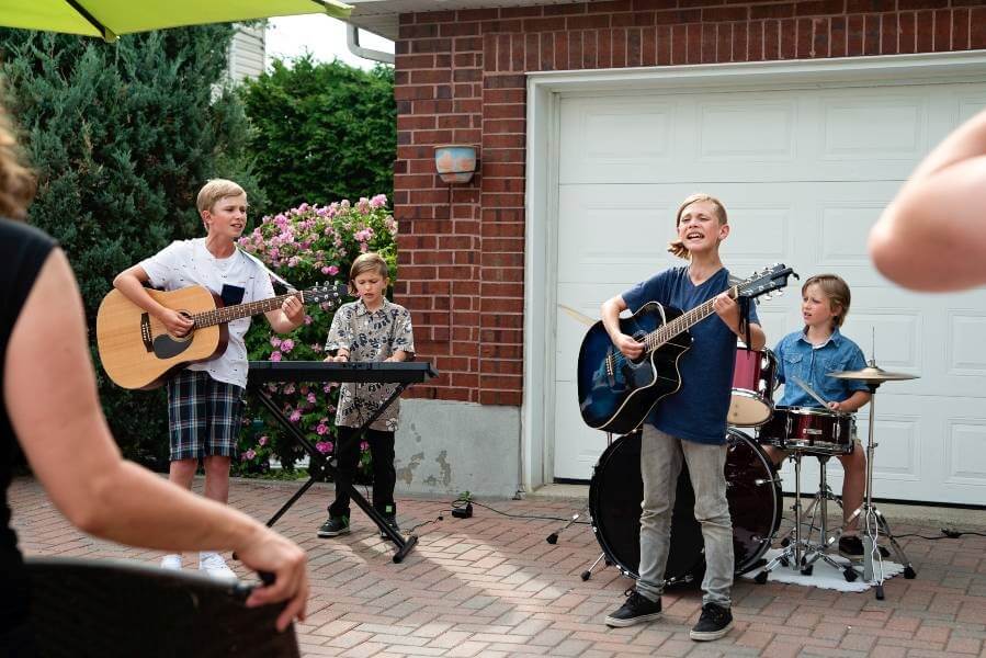 Children enthusiastically playing music outside Chicago, IL, creating a lively and engaging atmosphere