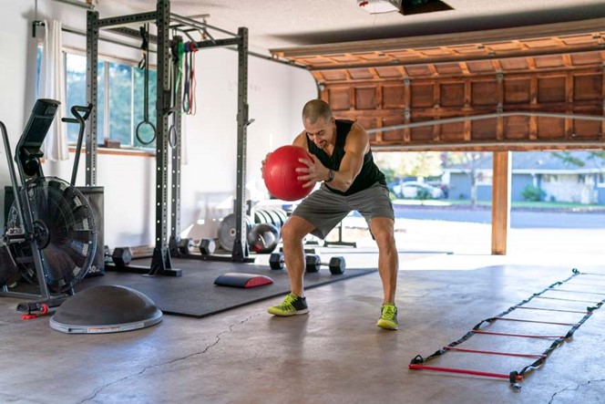 A man exercising in garage gym