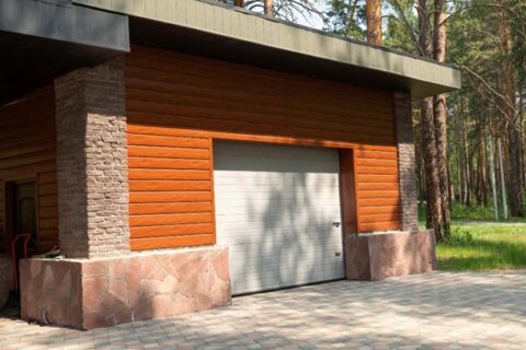 A modern white garage door with decorative panels